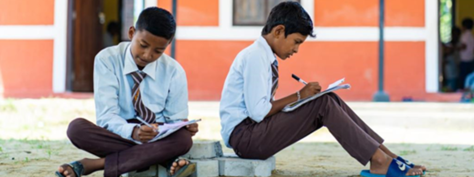 Two Nepal school children studying